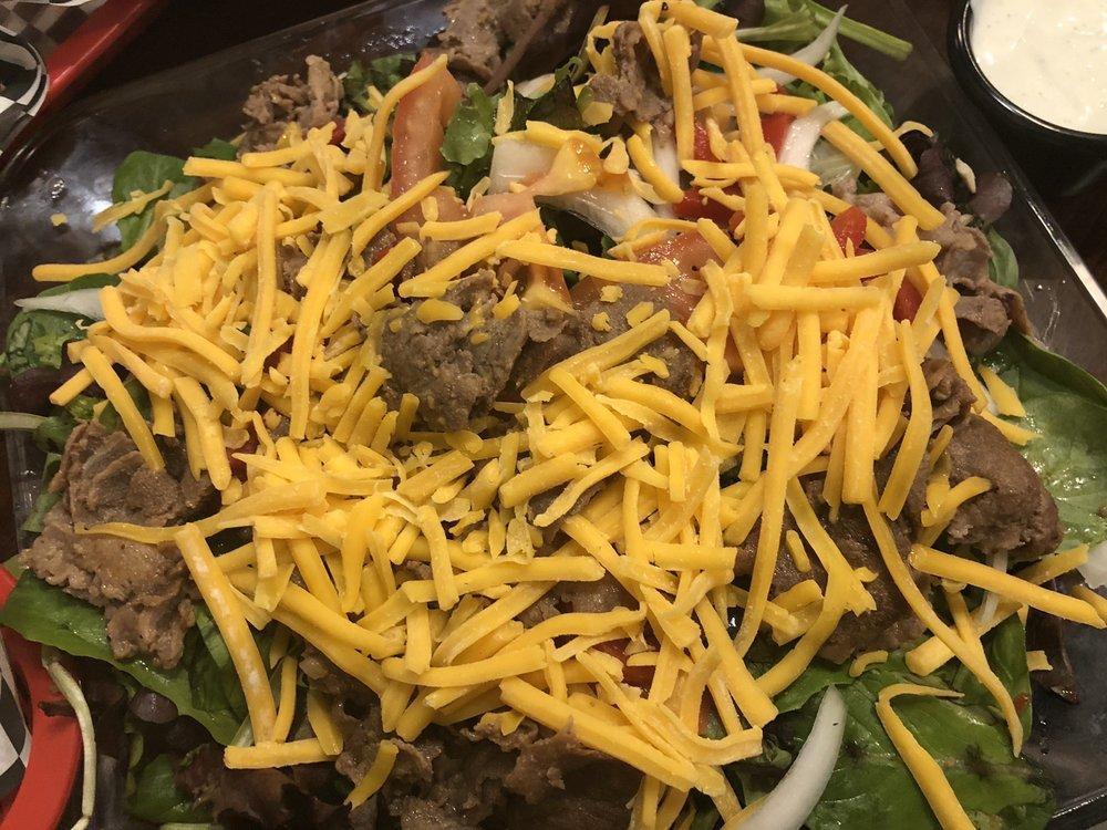 Philly Steak Salad · Served on a bed of fresh mixed greens with mushrooms, onions, sweet peppers, tomatoes and cheese.