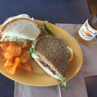 Rio Grande Club Sandwich · Turkey breast, hickory smoked bacon, pepper jack cheese, tomato and lettuce topped with Erik...