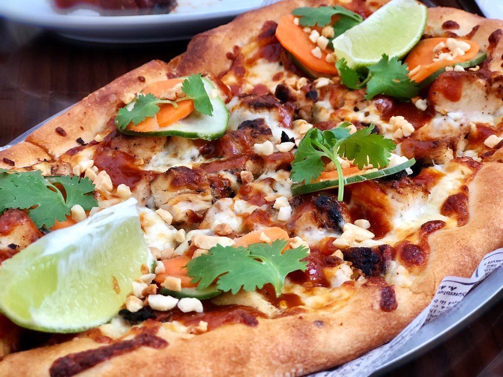 Crunchy Thai Flatbread · Grilled chicken breast, pickled carrots, cucumbers, cilantro and chopped peanuts with a spicy peanut glaze.