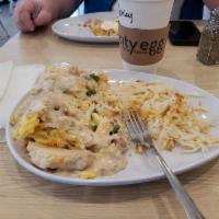 Big City · A layering of biscuits and golden hash browns piled high with 2 eggs any style, smothered in...