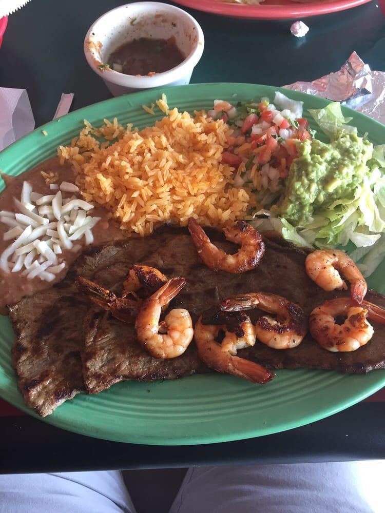 Carne Asada · Roasted steak served with rice, beans, and salad.
