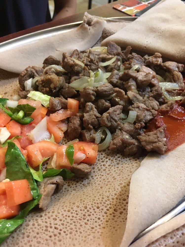 Habesha Tibs · Well done, medium well or juicy. Tender beef sauteed with onion and jalapeno with a touch of fresh garlic, tomato and sauce.