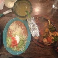 Shrimp Fajitas · Grilled tender shrimp, with bell peppers, onions, tomatoes, and all mixed. Served with flour...