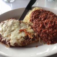 Chicken Parmigiana · Breaded chicken breast topped with marinara sauce and mozzarella cheese, served with pasta a...