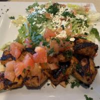 Chicken Shish Kebab · Grilled skewered chicken, marinated in garlic and tomatoes. Topped with fresh tomato mix.