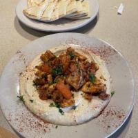 Shawarma · Thinly sliced seasoned filet tenderloin, sauteed with tomatoes and onions. Topped with tahin...