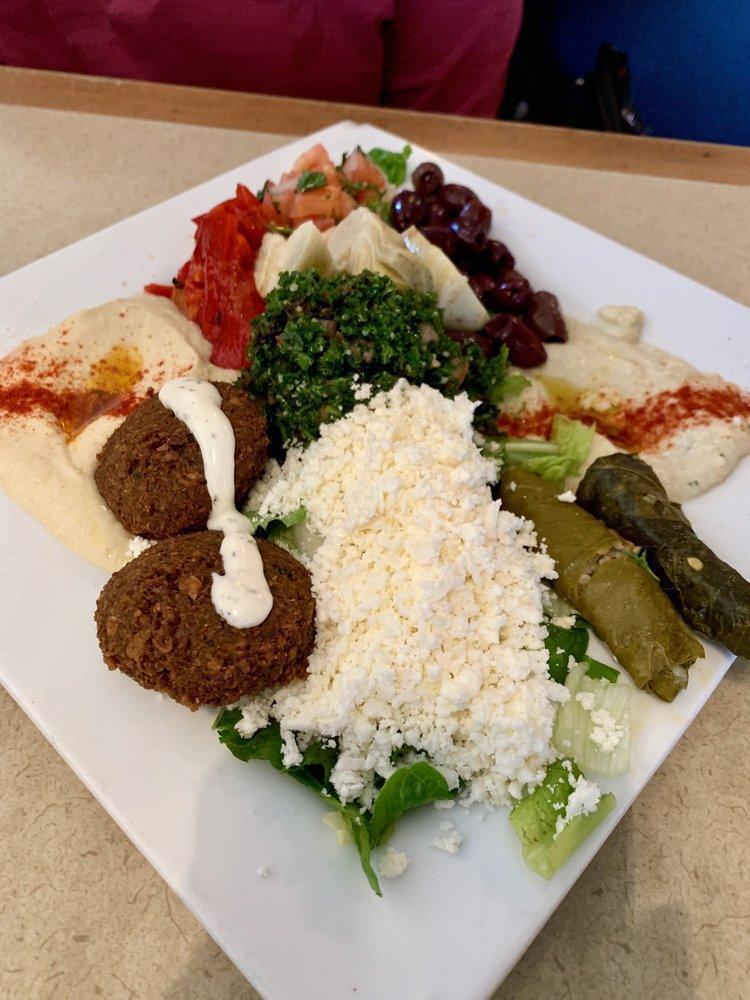 Mediterranean Combo Platter · A mixed platter with hummus, baba ghanouj, dolma, tabbouli, falafel, feta cheese, artichokes, roasted red pepper, Greek olives and tomatoes. Served with warm pita.