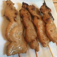 4 Piece Moo Ping · Grilled marinated pork on skewer with tasty spicy sauce on top.