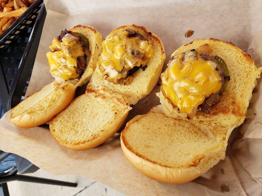 Sliders · 3 Hereford beef sliders served on Martin’s potato roll with American cheese, sauteed onions and a pickle.