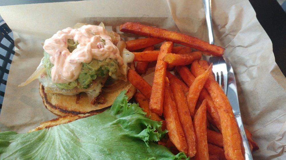 California Burger · Our fresh patty topped with pepper jack cheese, homemade guacamole and roasted red bell pepper sauce, topped with lettuce, tomato and raw onions.