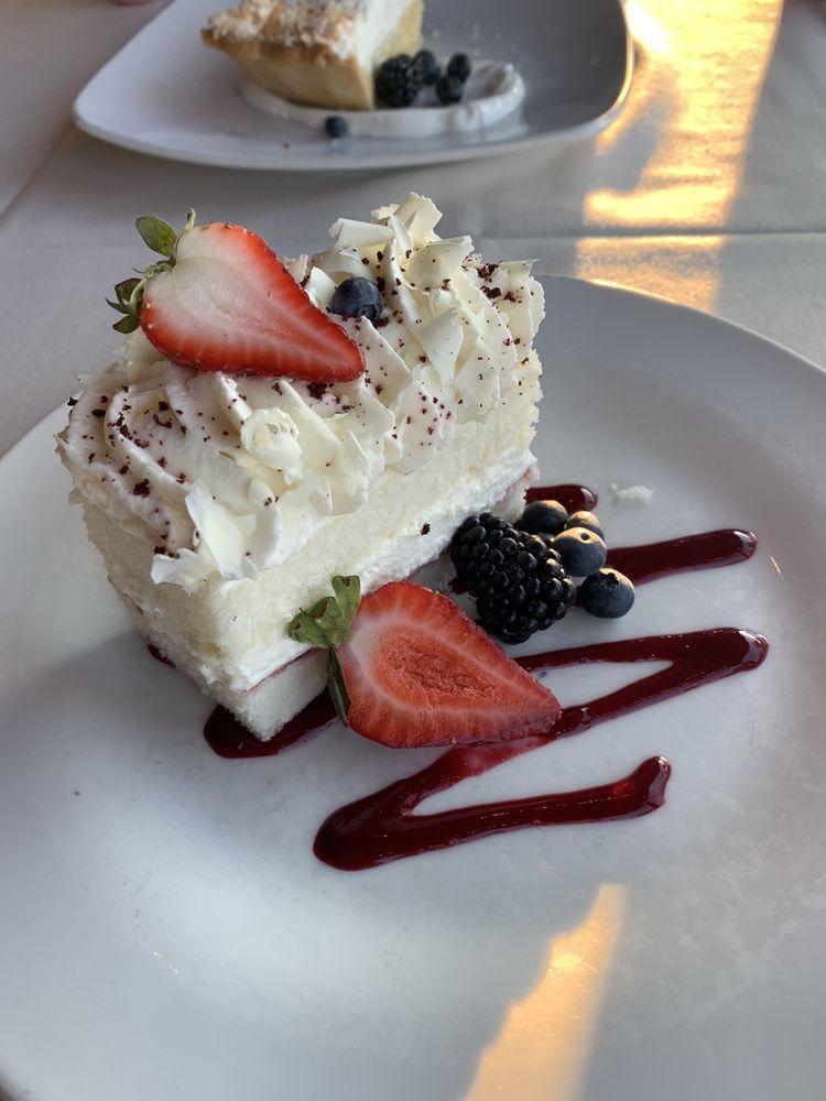White Chocolate Mousse Cake · Raspberry coulis.