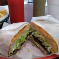 Tortas · Telera bread with choice of meat with beans, cheese, lettuce, tomatoes, mayonnaise, sour cre...