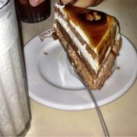 Caramel Cake · Layers of chocolate sponge cake filled with chocolate mousse and vanilla cream topped with c...