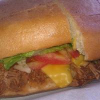 Lomo Torta · Slow-cooked shredded pork, cheese, lettuce, tomato, avocado, mayo.