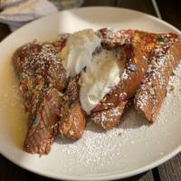 Cereal Killer French Toast · Battered in fruity pebbles and served with a vanilla frosting glaze.
