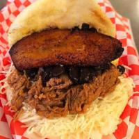Pabellon Arepa · White corn meal pocket filled with shredded beef, black beans, grated monterey jack cheese &...