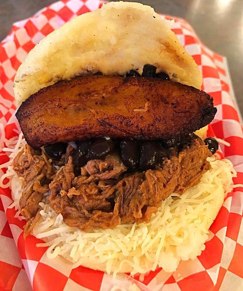 Pabellon Arepa · White corn meal pocket filled with shredded beef, black beans, grated monterey jack cheese & sweet plantain
