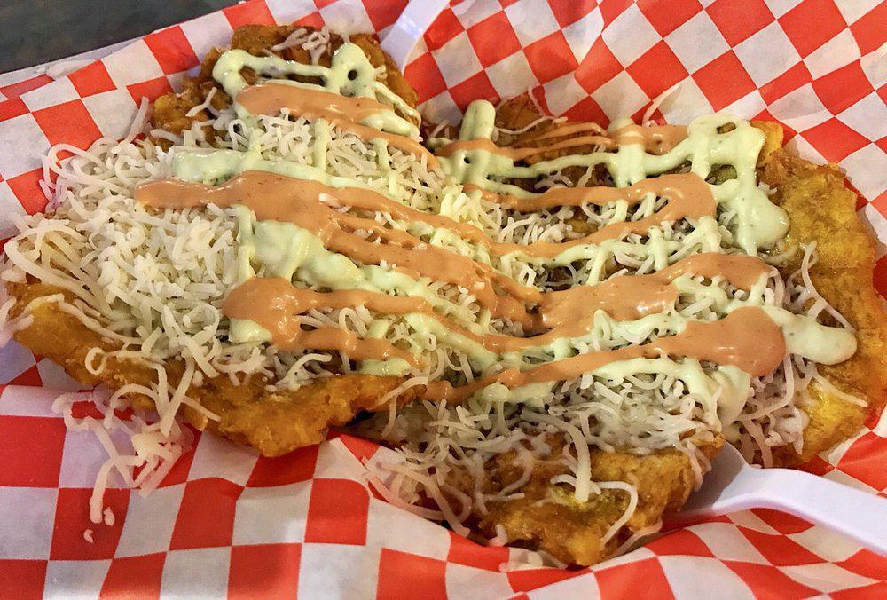 Tostones · Plantain chips topped with  monterey jack cheese and pink mayo sauce (5 per serving)
