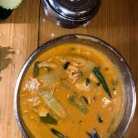 Red Curry · Red curry with coconut milk, bamboo shoots, bell peppers and basil.