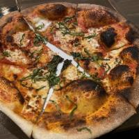 Margherita Pizza · Traditional pizza with extra famous sauce and fresh basil.