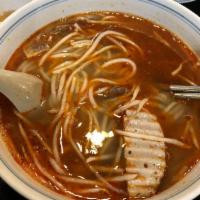 E17 Bun Bo Hue · Vietnamese large round rice noodles spicy soup with beef shanks, beef tendon and slice of po...