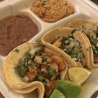Shrimp Tacos · 3 shrimp tacos topped with onions, cilantro and your choice of corn or flour tortillas. Serv...