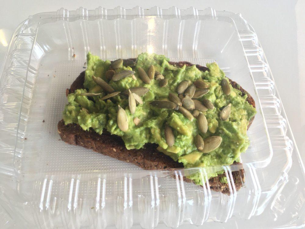 Avocado Toast · Whole avocado on squaw bread, pumpkin seeds, salt, pepper and chipotle sauce.