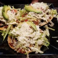 Tostadas · Toasted corn tortillas topped with black beans, choice of meat, lettuce, tomatoes, onions, s...