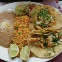 Fish Tacos · 2 corn tortillas filled with fish, served with guacamole, pico de gallo, rice and beans.