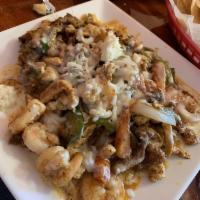 Margarita Special · Rice, chicken, steak, shrimp, onions, bell pepper, mushrooms and cheese on top.