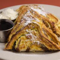 Cinnamon Raisin French Toast · A signature! Egg battered cinnamon raisin bread, whipped butter and maple syrup. White or so...