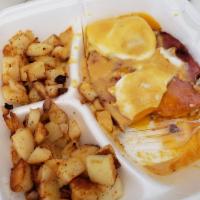 Eggs Benedict · Smoked ham, poached eggs, hollandaise, fresh chives and English muffins. Served with hash br...