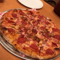 Meat Deluxe Pizza · Pepperoni, ham, sausage, prosciutto and bacon.