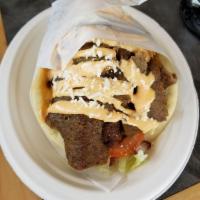 Lamb Gyro · Slow roasted lamb and beef slices, seasoned with our special Mediterranean spices topped wit...