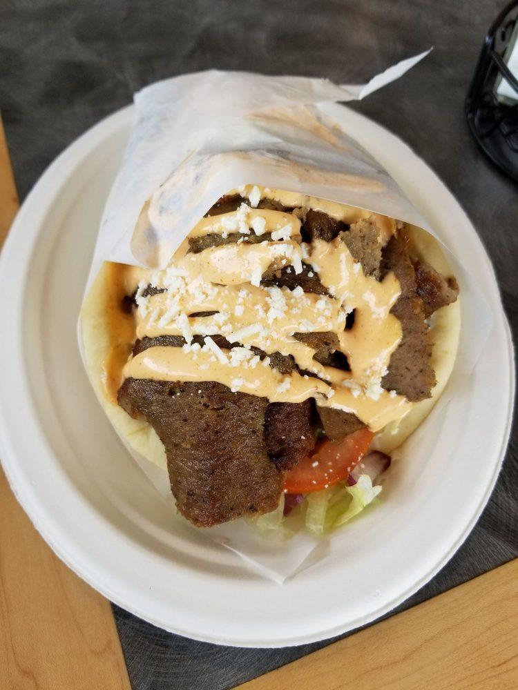 Lamb Gyro · Slow roasted lamb and beef slices, seasoned with our special Mediterranean spices topped with tzatziki sauce and wrapped in a soft, warm pita.