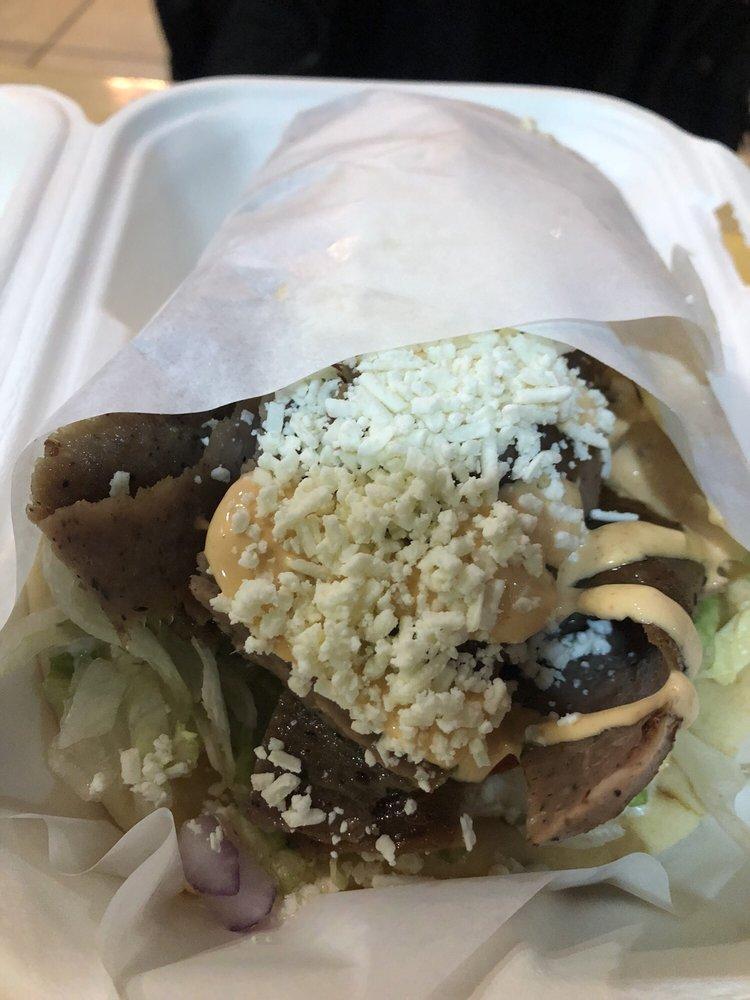 Spicy Lamb Gyro with Feta · Slow roasted lamb and beef sliced and seasoned with our special Mediterranean spices with lettuce, tomatoes, pickles and onions, topped with feta cheese and spicy garlic sauce and wrapped in a soft, warm pita.
