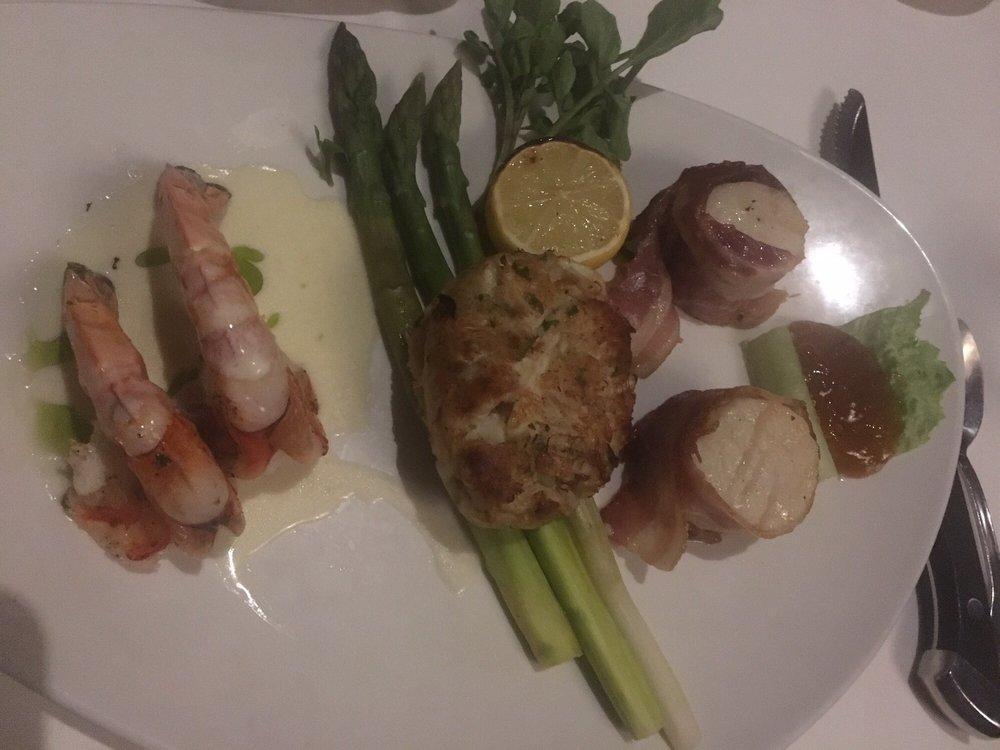 Filet Mixed Grill · 6 oz. filet mignon , 2 bacon-wrapped scallops with  apricot chutney  and 2 jumbo grilled shrimp atop Beurre Blanc, served with asparagus