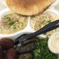 Vegetarian Plate · Hummus, tobouleh salad, and falafel, stuffed with grape leaves and baba ghanouj.