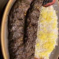 Koobideh Kabob · Seasoned ground sirloin, mixed with grated onions and rolled around skewer, broiled on open ...