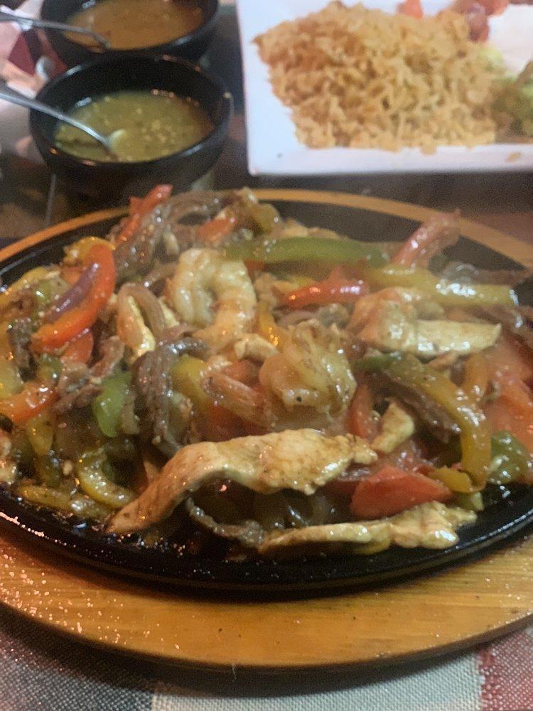 Ultimate Fajitas · Chicken, shrimp, and steak with bell peppers served on a sizzling skillet with sides of sour cream, guacamole, pico de gallo, lettuce and queso fresco and served with Mexican rice, peruano or black beans and handmade corn tortillas.