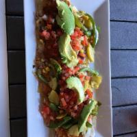 Huarache · 1, foot-long, bean-stuffed tortilla topped with melted Oaxaca cheese, your meat of choice th...
