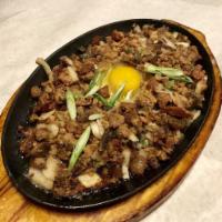 Sizzling Sisig · Finely chopped pork belly marinated with lemon and hot peppers and served on a hot plate.