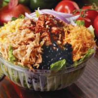 BBQ Chicken Salad · Barbecued chicken breast tossed with romaine, cheddar, corn, red onions, and black beans, to...