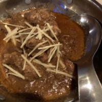 Chicken Korma · Chicken pieces cooked with spices in a savory curry.
