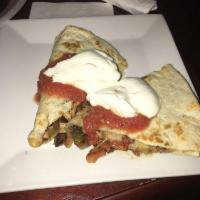 Quesadilla · A flour tortilla grilled with a cheese blend, onion and peppers. Served with salsa and sour ...