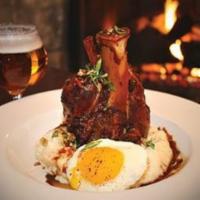 Slow Braised Pork Shank · cheesy bacon grits, sofrito, and grilled baby carrots.