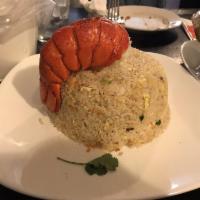 Lobster Fried Rice · Fried rice infused with chunks of lobster meat and topped off with a whole lobster tail.