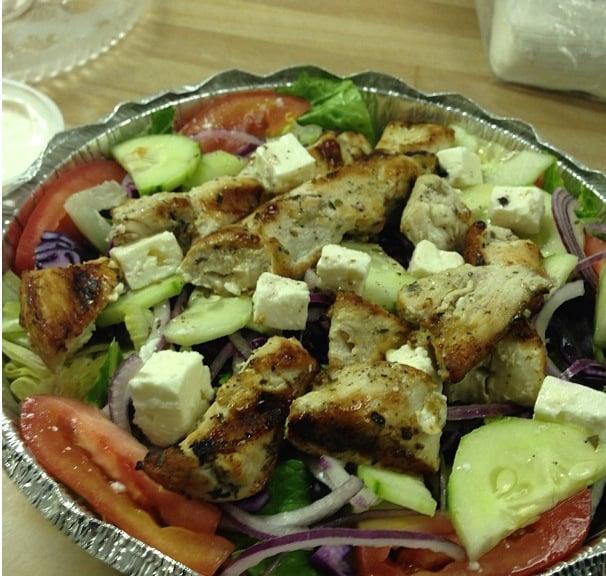 Greek Salad · Iceberg and romaine lettuce, tomato, cucumber, red onion, red cabbage, feta cheese, Kalamata olives and grape leaves. Served with pita bread.