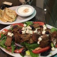 Gyro Salad · Mixed greens, cucumbers, tomato, onion, red cabbage, feta, and olives topped with gyro meat....