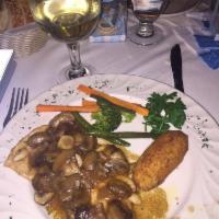 Chicken Marsala · Breast of chicken sauteed in Marsala wine and mushroom. Served with vegetables of the day.